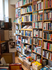 A cozy room filled with shelves of spiritual books in Romanian.
