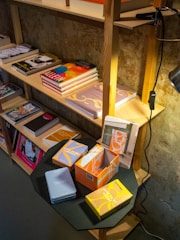 A neat stack of transparent storage boxes filled with household items on a wooden shelf.