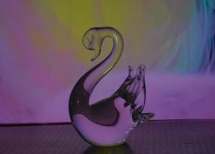 A stunning ice sculpture of a swan glistening under soft lighting at an elegant event.