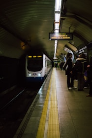 a train pulling into a train station next to a platform