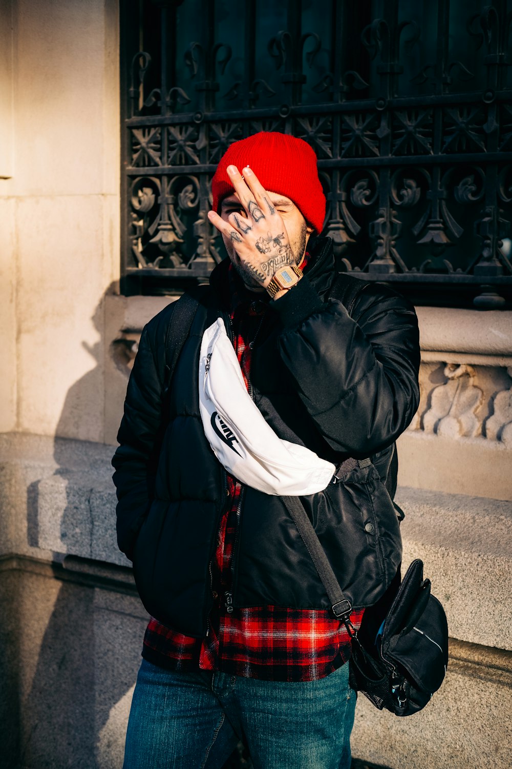 a man wearing a red hat and black jacket