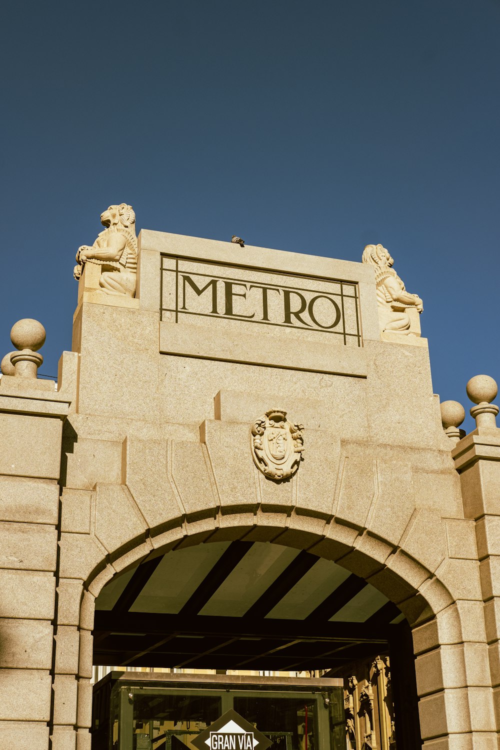the entrance to metro station with a clock on it