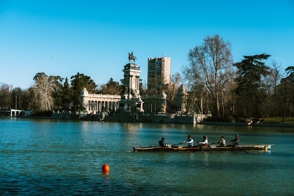 a group of people riding on top of a boat on a lake