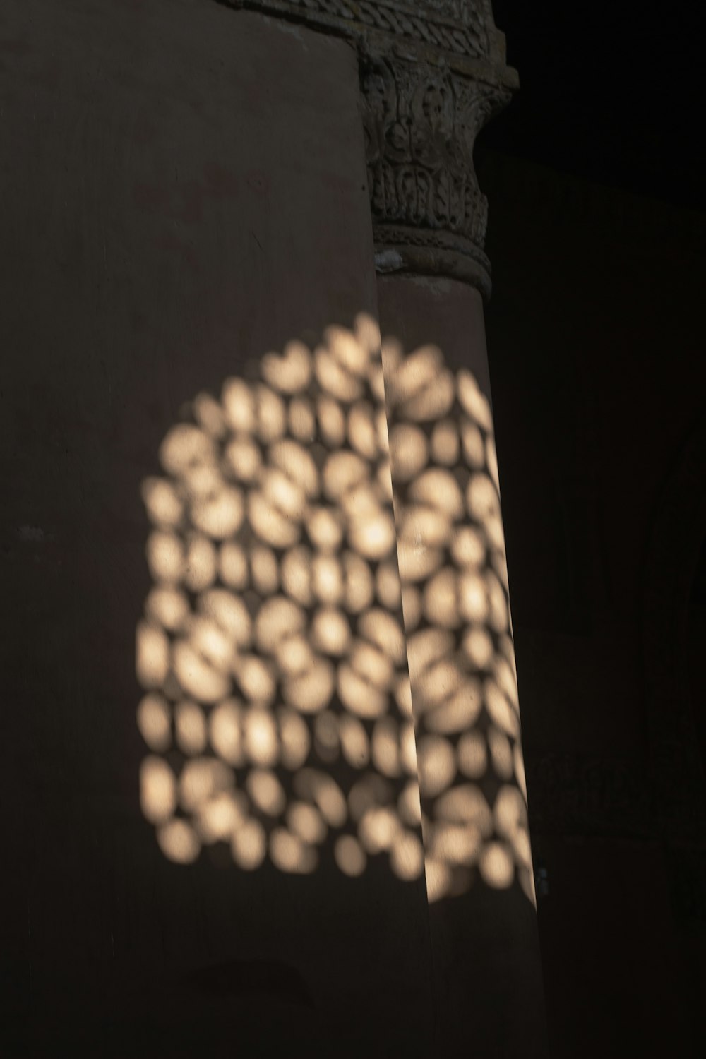 a shadow of a building with a clock on it