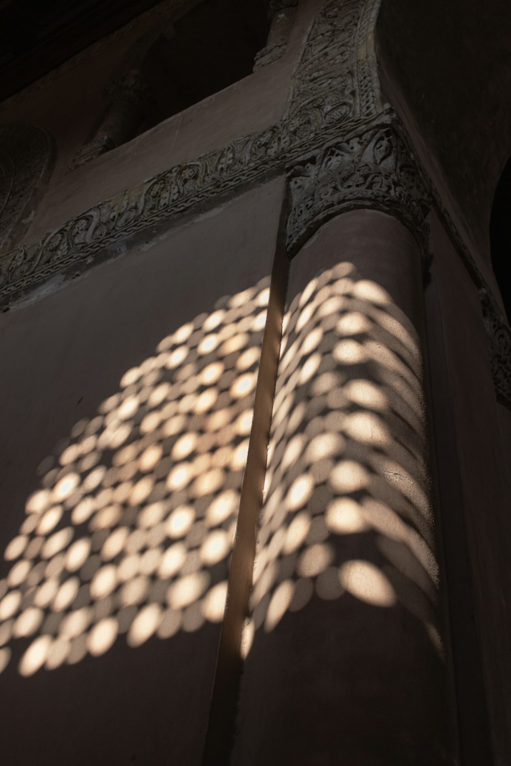 the shadow of a building on the wall