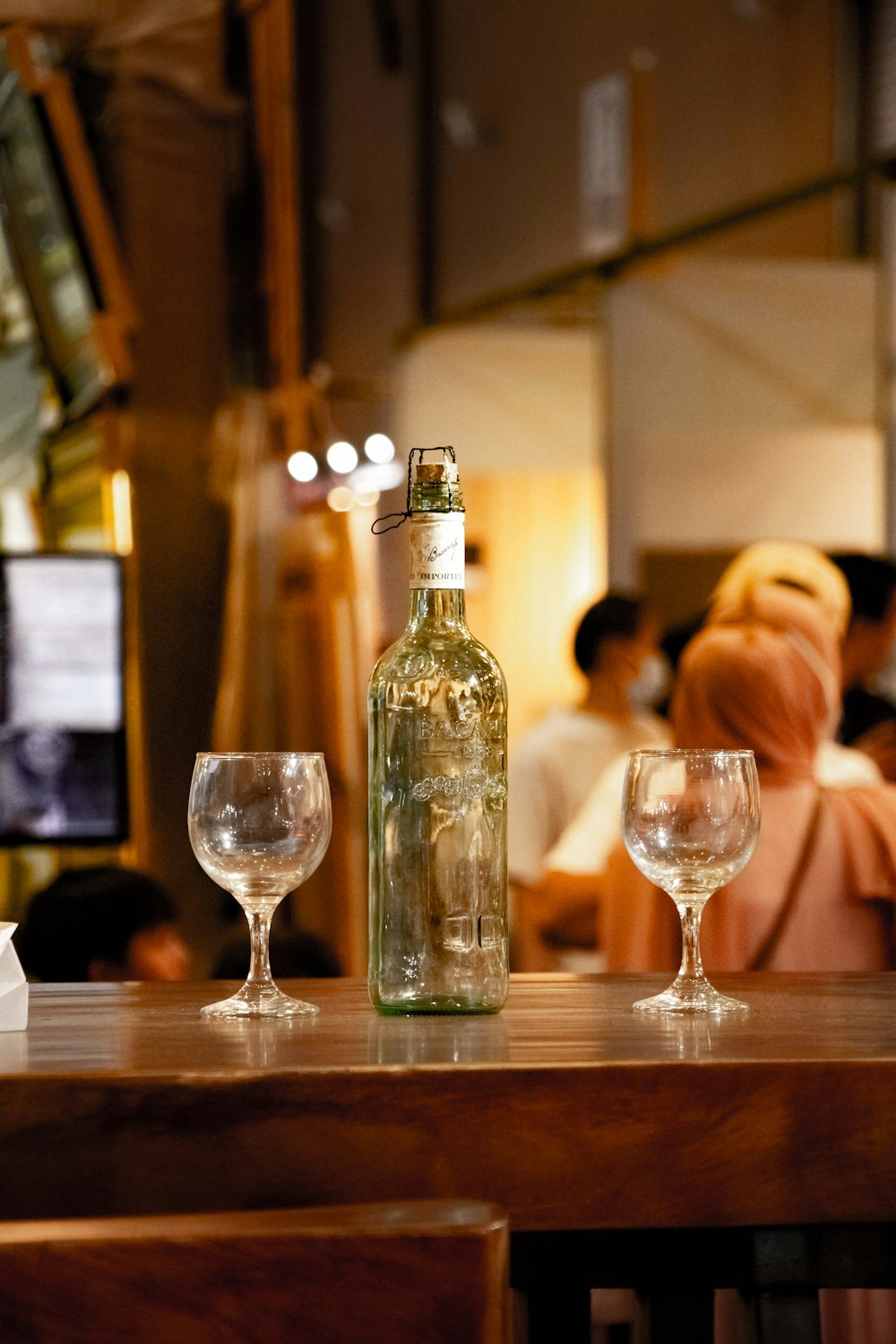 a bottle of wine sitting on top of a wooden table