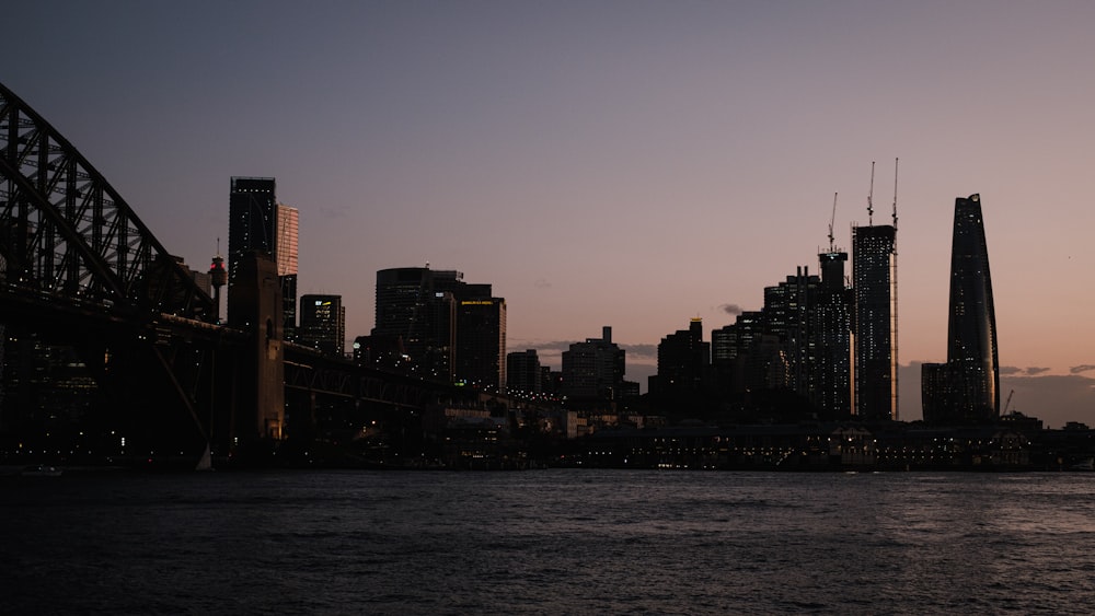 a city skyline with a bridge in the foreground