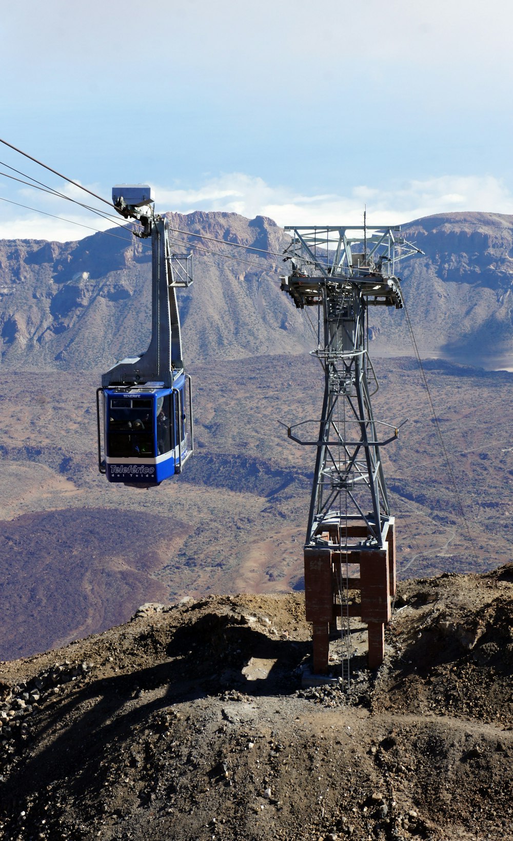 a blue and white ski lift going up a mountain