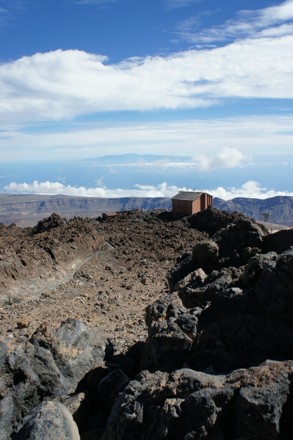 a rocky area with a building on top of it