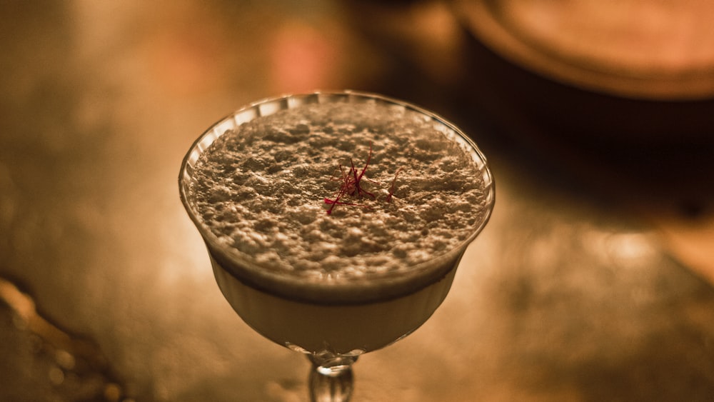 a close up of a drink in a glass on a table