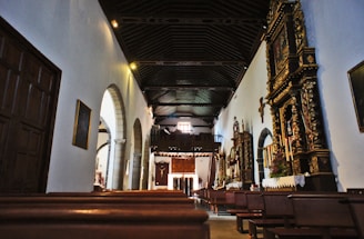 A serene worship setting with soft white tones and glowing gold accents.