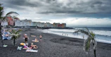 Golden sands of Labadi Beach with locals enjoying the sun.