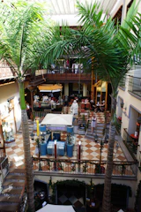 A bustling multi-floor pet mall with happy pets exploring shops, a cozy pet library, and a lively food court filled with pet treats.