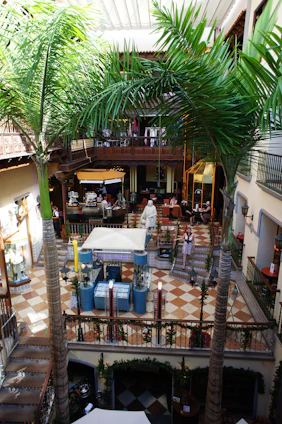 A bustling multi-floor pet mall with happy pets exploring shops, a cozy pet library, and a lively food court filled with pet treats.