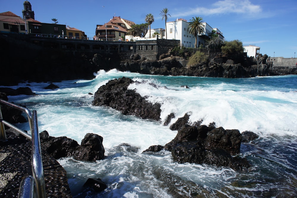 a rocky shore with waves crashing against the rocks