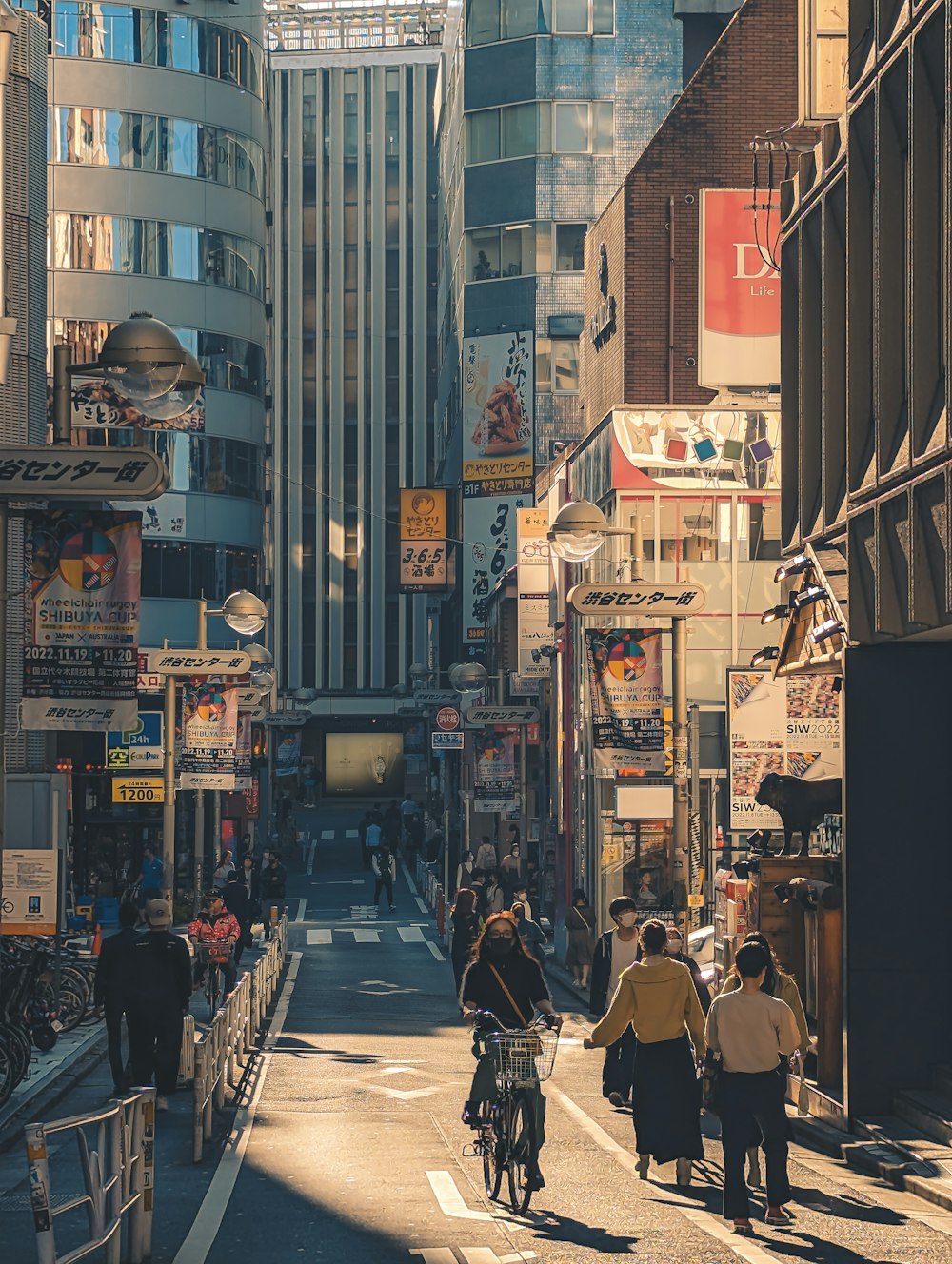 a group of people riding bikes down a street