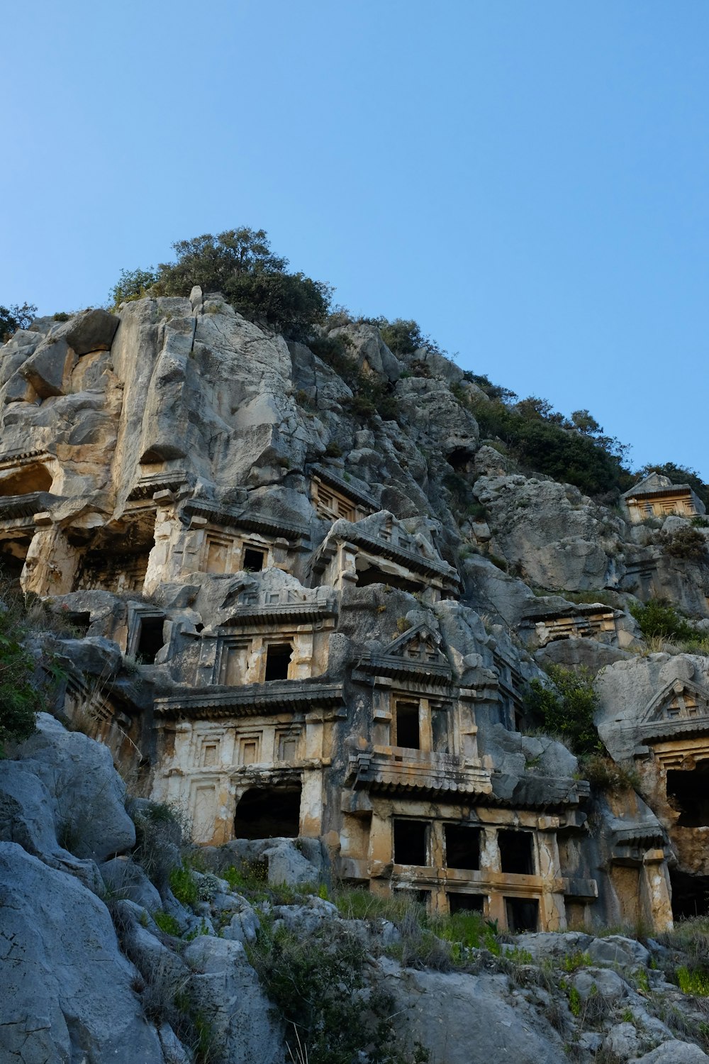 a mountain side with a bunch of buildings built into the side of it