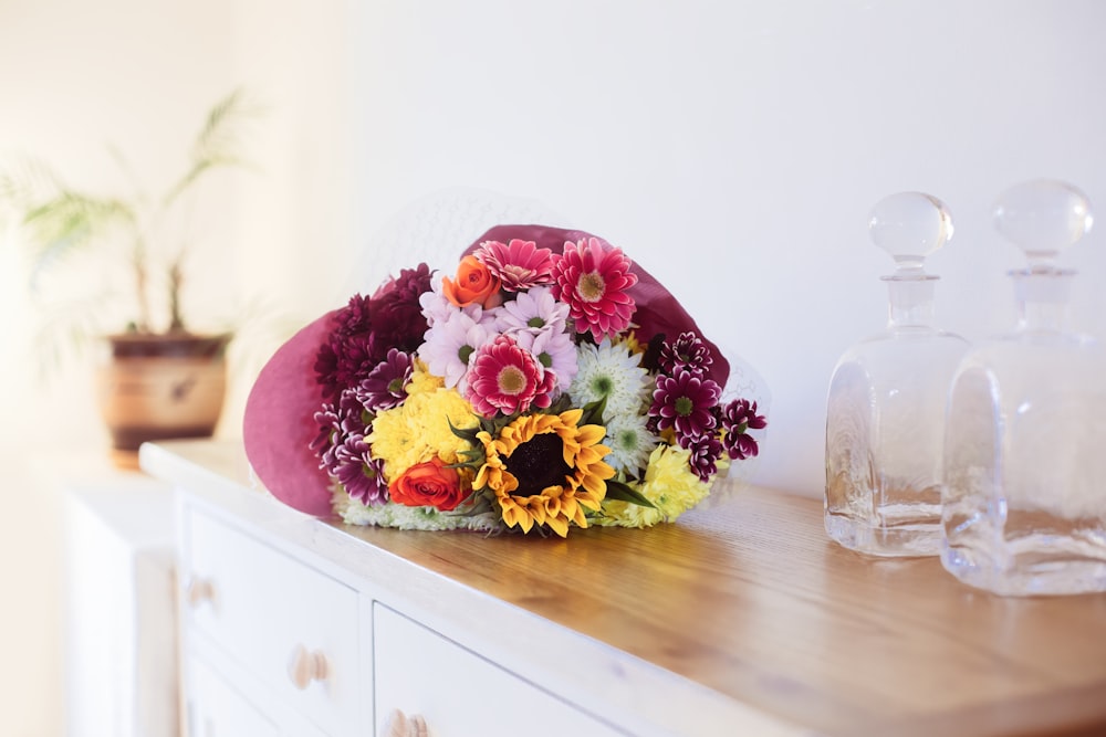 a bouquet of flowers sitting on top of a wooden table