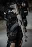 a man in camouflage holding a machine gun