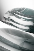 Abstract organic forms in motion, layered with subtle depth and contrast against a muted background.