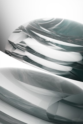 Abstract organic forms in motion, layered with subtle depth and contrast against a muted background.