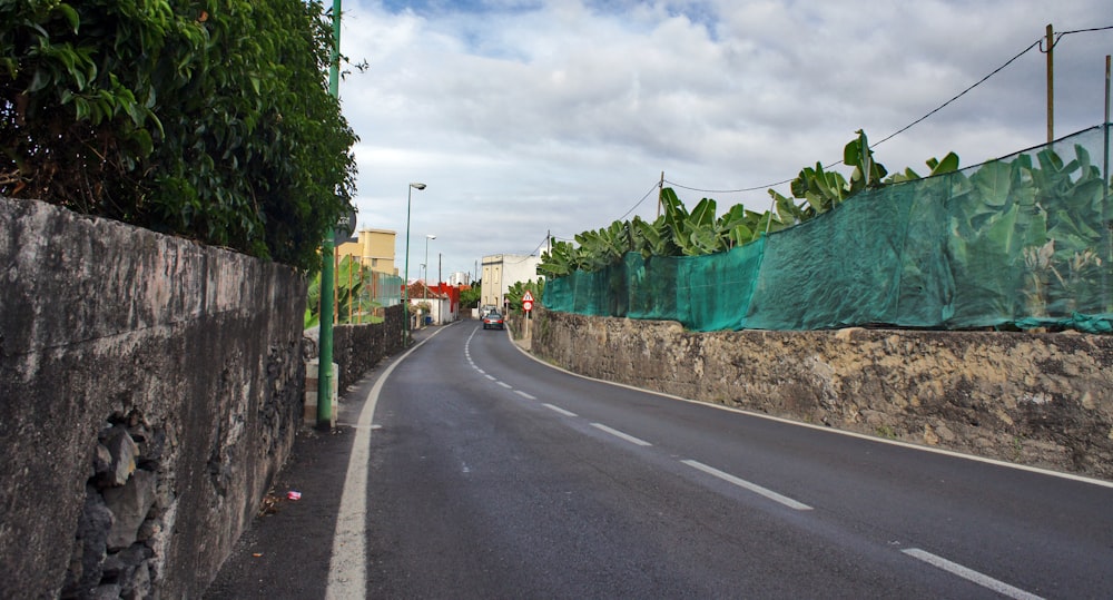 a road with a green tarp on the side of it