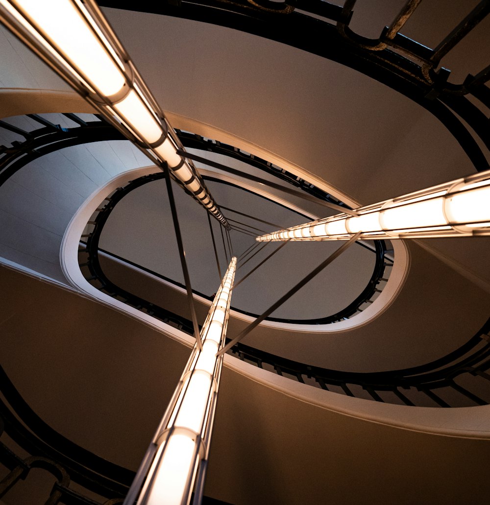 a spiral staircase in a building with a skylight