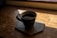 A steaming cup of dark coffee on a rustic wooden table with morning light streaming in.