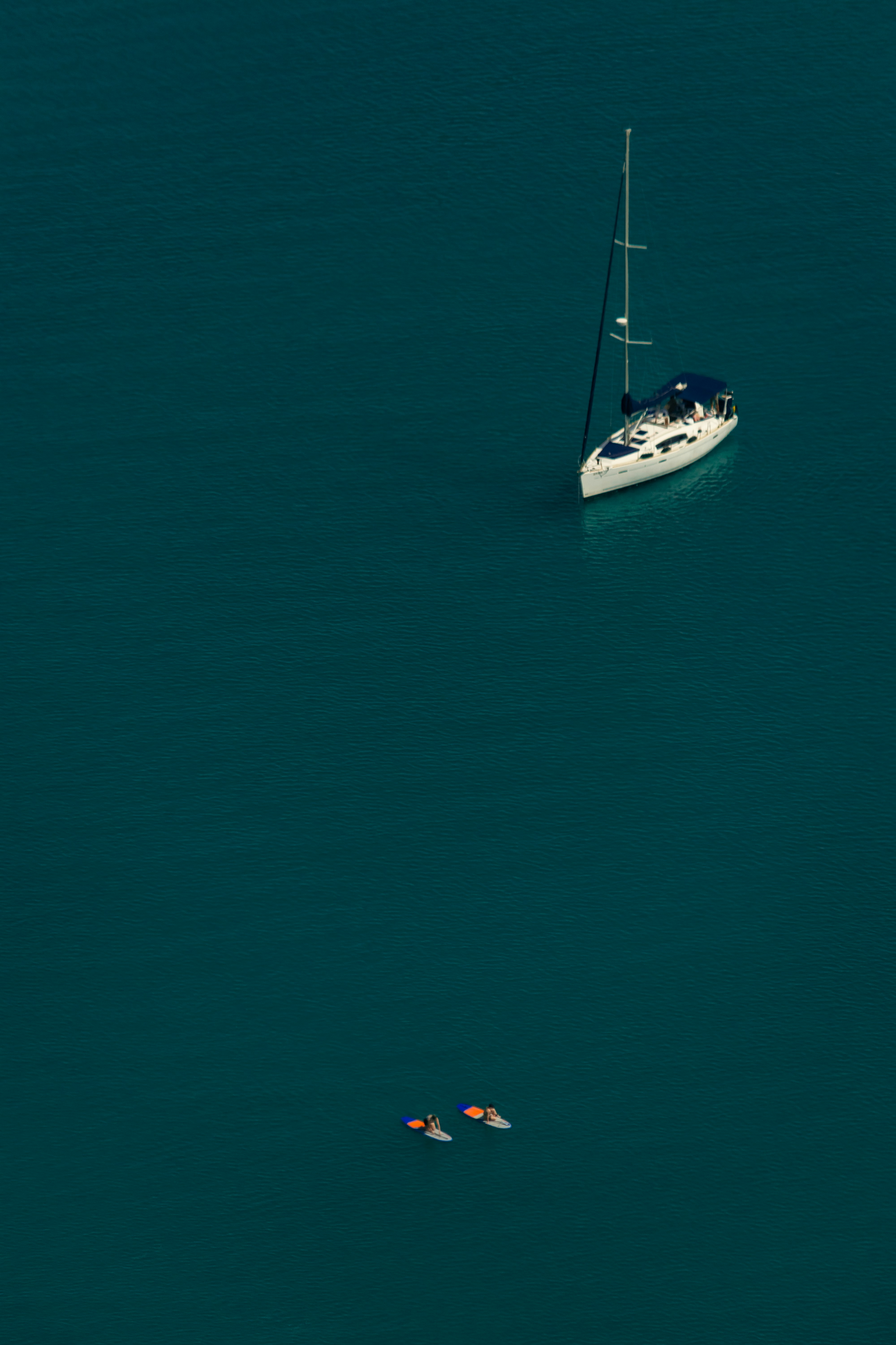 a couple of boats floating on top of a large body of water