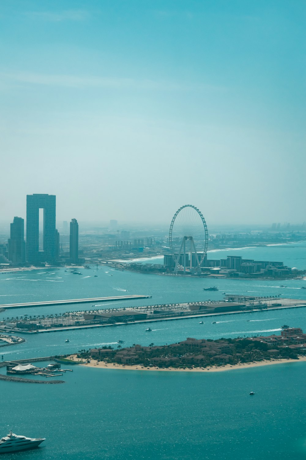 a large body of water with a ferris wheel in the background