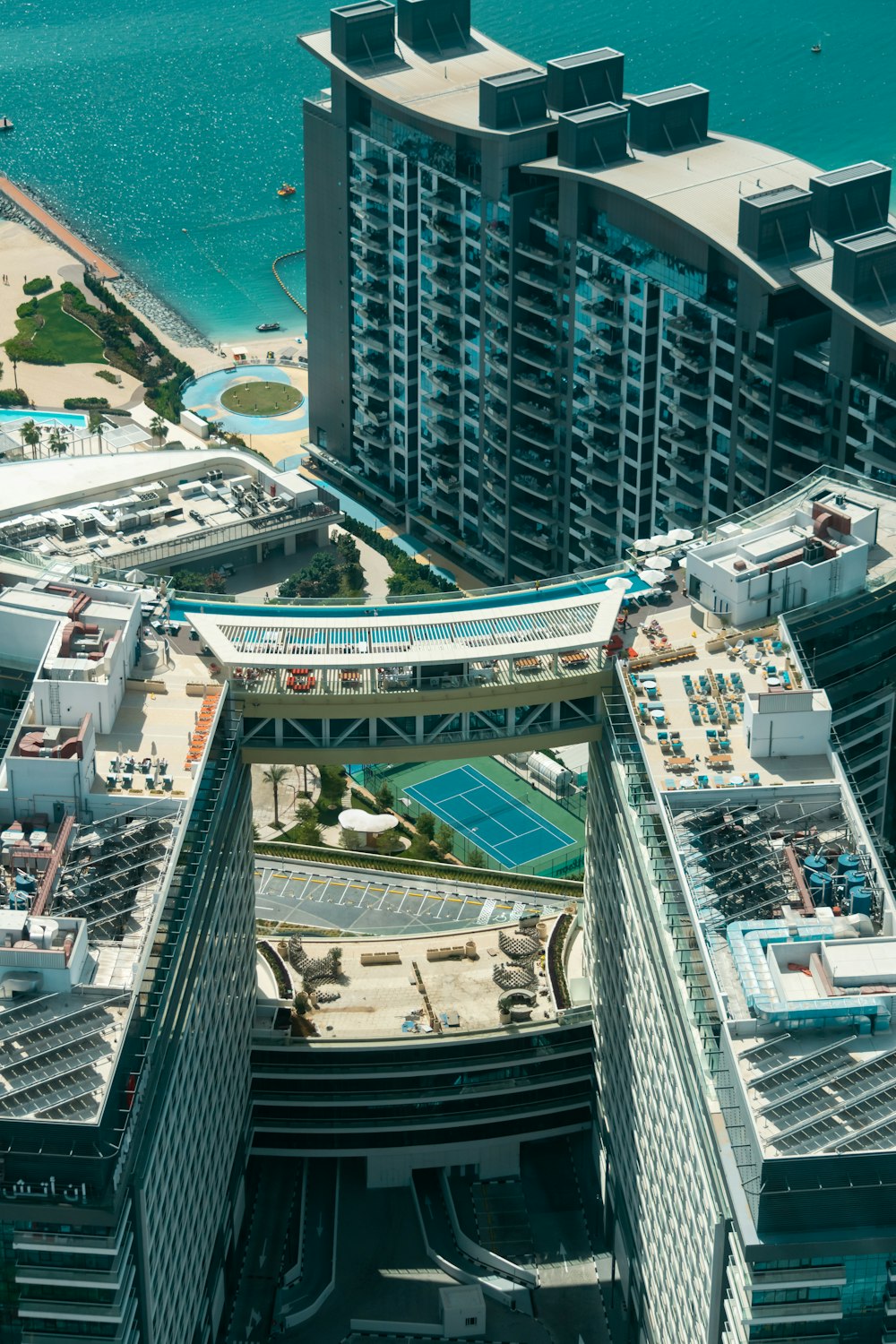 an aerial view of a city with a tennis court