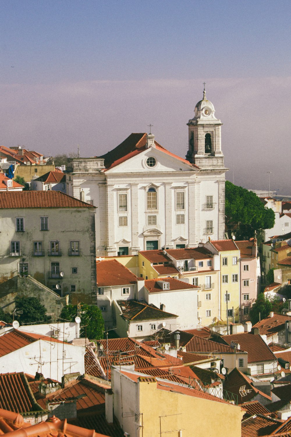 a view of a city with a church in the background