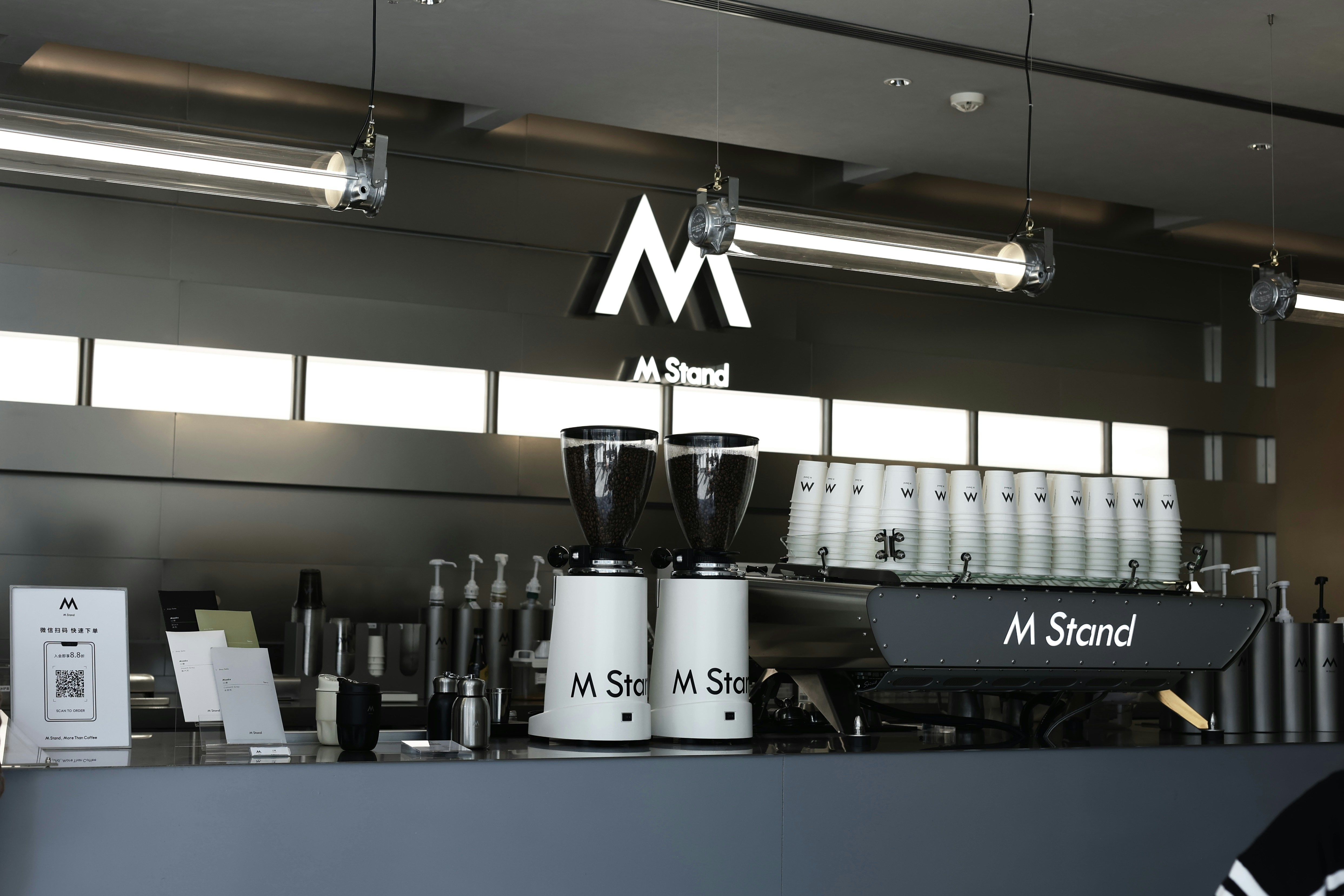 a coffee shop with a sign above the counter