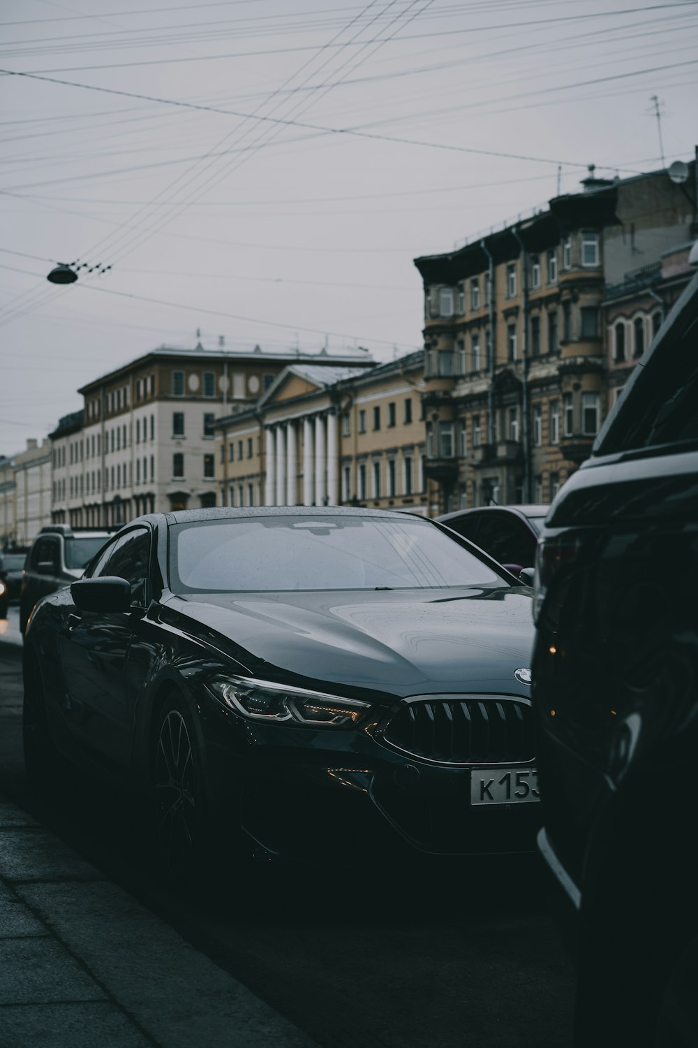 a black car parked on the side of a road