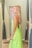 A happy customer trying on a fashionable dress in a bright fitting room.