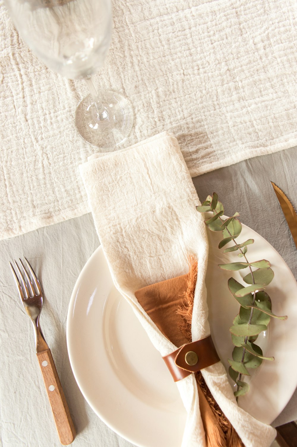 a white plate topped with a napkin and a fork