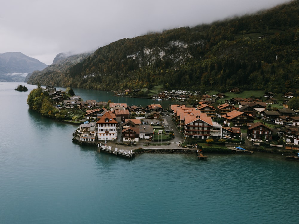 an aerial view of a village on a lake