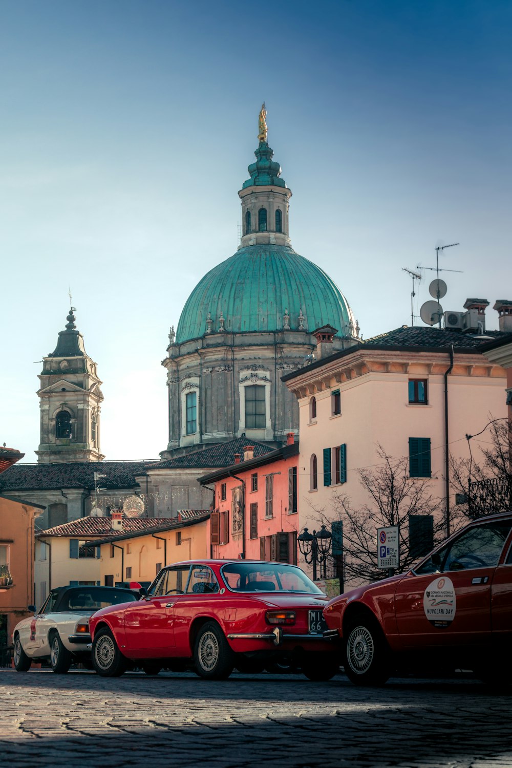 a couple of cars parked in front of a building