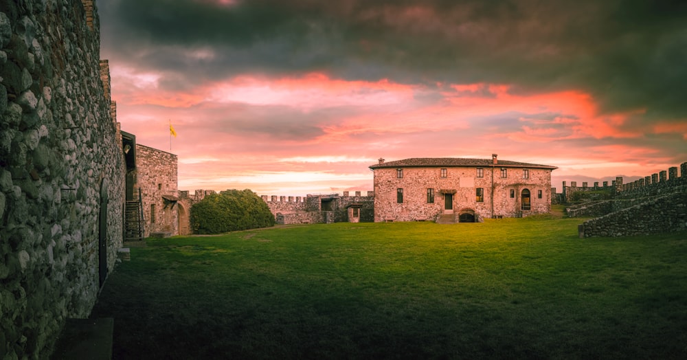 a large building sitting on top of a lush green field