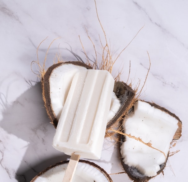 a popsicle is sitting on top of a coconut