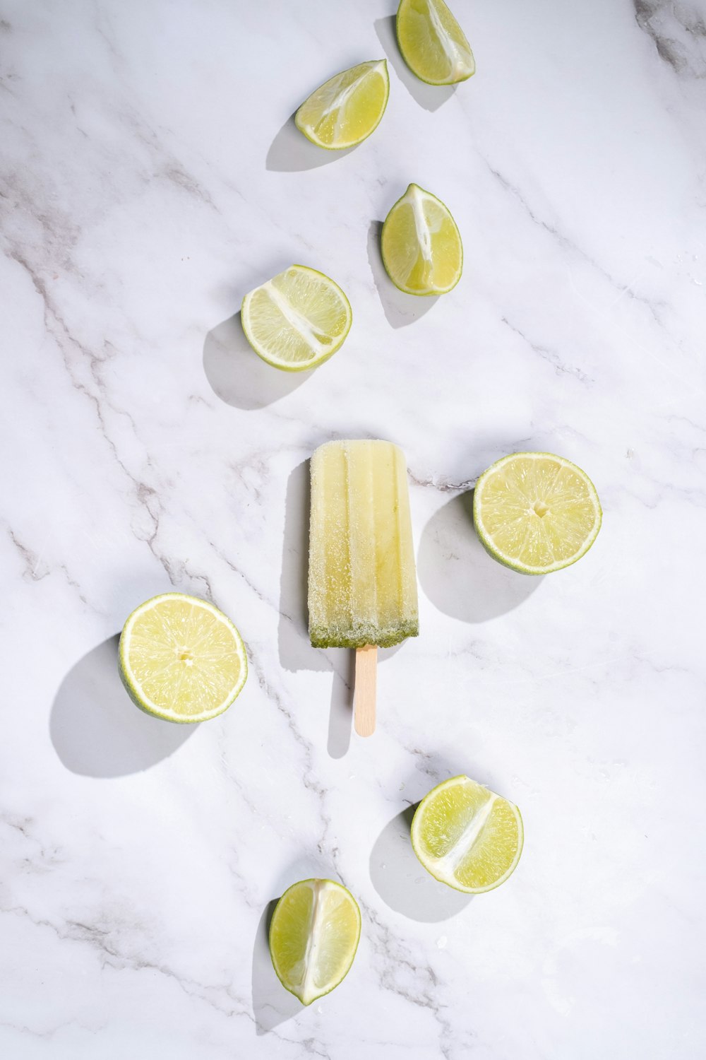 a popsicle with lemon slices on a marble surface
