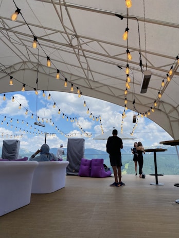 Chic outdoor lounge area featuring plush seating and ambient lighting under a stylish tent.