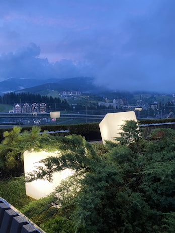 An artistic rendering of a serene landscape with a glowing capsule buried beneath the earth.