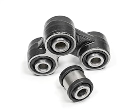 A close-up of metal mechanical components consisting of multiple rubber bushings. The bushings are primarily black with a metallic silver inner ring and are set against a plain white background.
