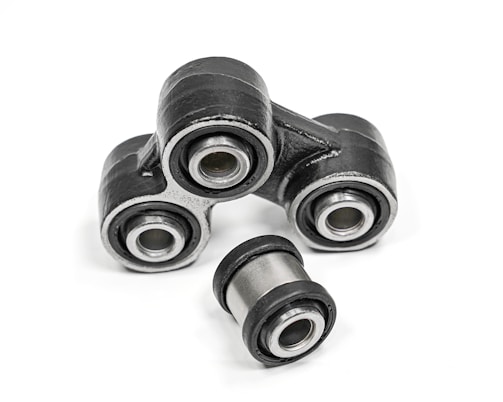 Image showing various sizes of bushings neatly arranged on a workshop table.