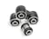 A close-up of metal mechanical components consisting of multiple rubber bushings. The bushings are primarily black with a metallic silver inner ring and are set against a plain white background.