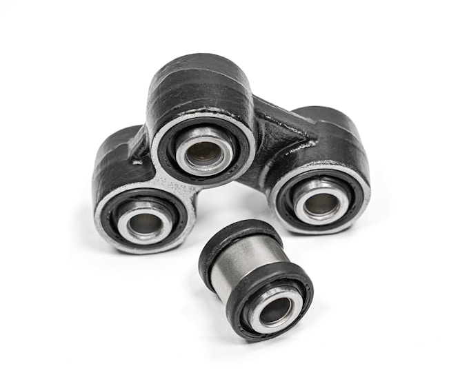 Close-up of a precision-engineered pin bush coupling in a heavy industrial setting.