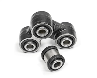 A close-up of metal mechanical components consisting of multiple rubber bushings. The bushings are primarily black with a metallic silver inner ring and are set against a plain white background.