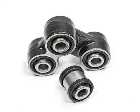 A close-up of metal mechanical components consisting of multiple rubber bushings. The bushings are primarily black with a metallic silver inner ring and are set against a plain white background.