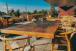 Elegant outdoor patio set with sleek chairs and a wooden table under soft natural light
